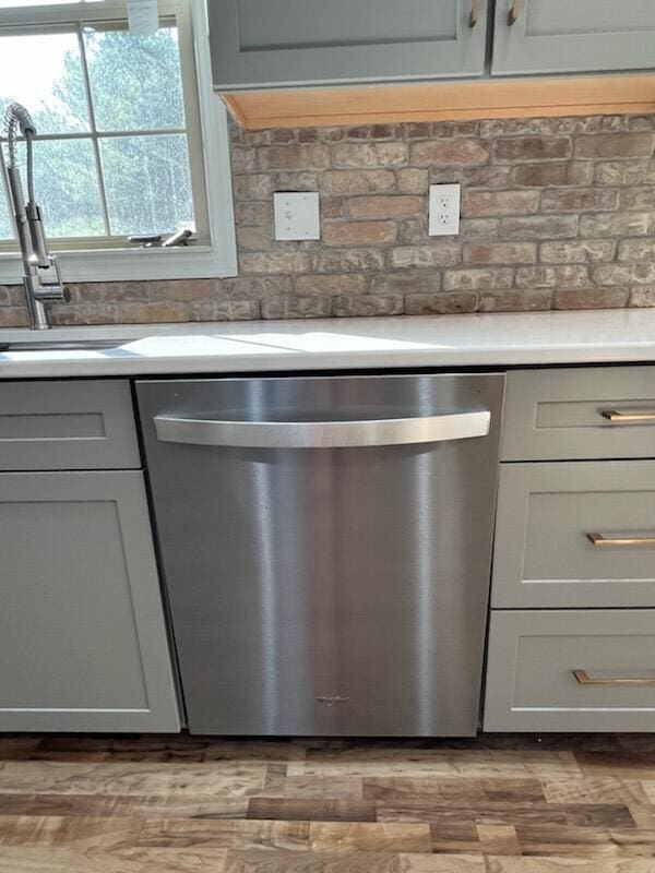 450 Village Ridge Ct, Powell, OH 43065 - kitchen view of dishwasher, light countertops, gray cabinetry, and light wood finished floors