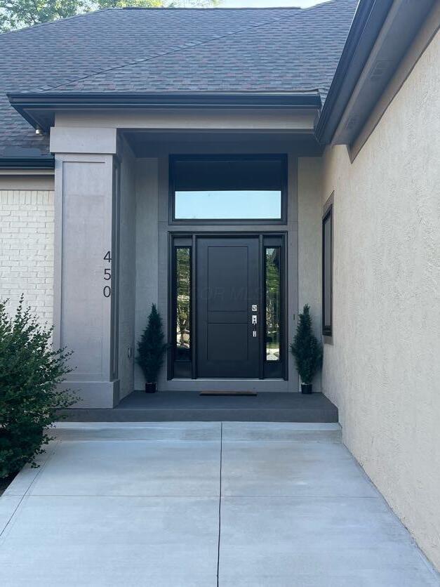 450 Village Ridge Ct, Powell, OH 43065 - entrance to property with a shingled roof and stucco siding