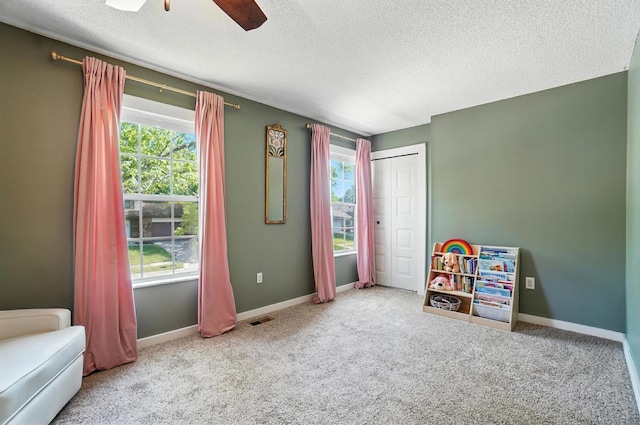 1817 Ibson Dr, Powell, OH 43065 - rec room featuring healthy amount of natural light, a textured ceiling, carpet, and a ceiling fan