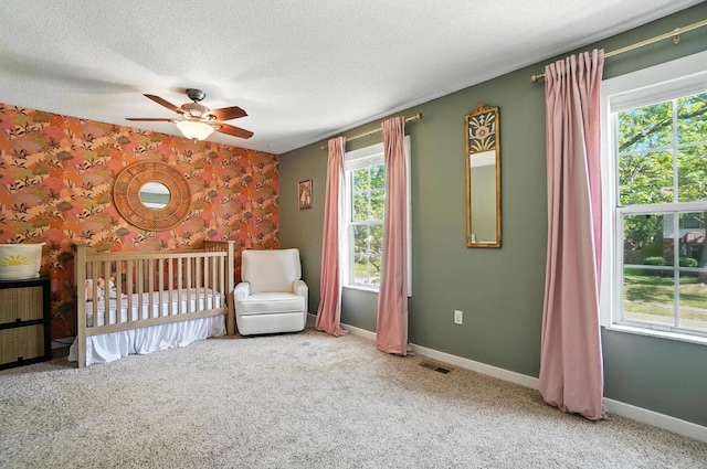 1817 Ibson Dr, Powell, OH 43065 - unfurnished bedroom with carpet floors, a crib, a textured ceiling, and ceiling fan