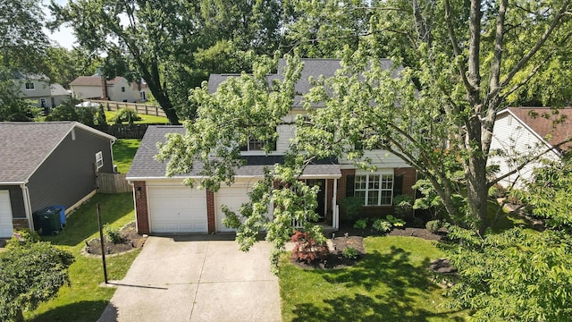 1817 Ibson Dr, Powell, OH 43065 - obstructed view of property with brick siding, driveway, a shingled roof, an attached garage, and a residential view
