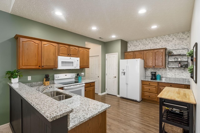 4124 Aumbrey Ct, New Albany, OH 43054 - kitchen featuring white appliances, wine cooler, a peninsula, wood finished floors, and brown cabinets