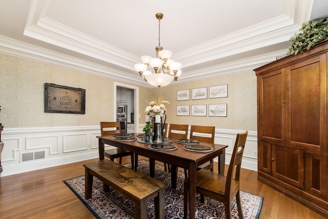 1828 Bradford Cir, Newark, OH 43055 - dining area with a tray ceiling, a chandelier, ornamental molding, wood finished floors, and wainscoting