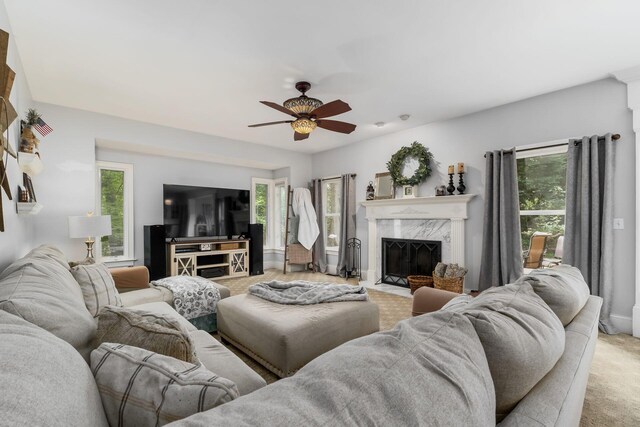 1828 Bradford Cir, Newark, OH 43055 - living area featuring light colored carpet, a ceiling fan, and a high end fireplace