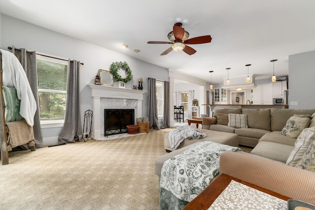 1828 Bradford Cir, Newark, OH 43055 - living area with carpet, ceiling fan, and a high end fireplace