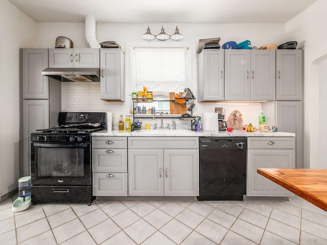 1482 Briarwood Ave, Columbus, OH 43211 - kitchen with black appliances, ventilation hood, gray cabinetry, light countertops, and tasteful backsplash