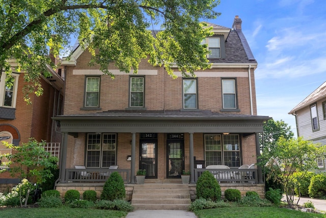 144 Wilson Ave, Columbus, OH 43205 - view of front facade with a porch and brick siding