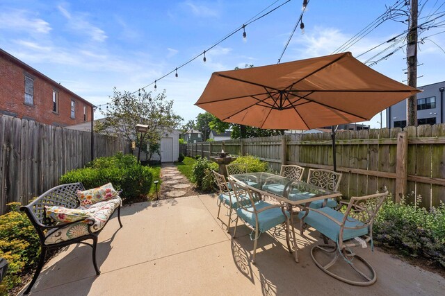 144 Wilson Ave, Columbus, OH 43205 - fenced backyard featuring a patio, outdoor dining space, and a shed
