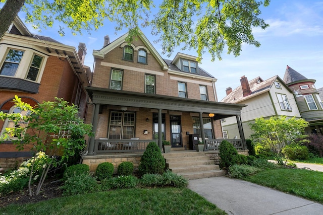 144 Wilson Ave, Columbus, OH 43205 - victorian house with covered porch and brick siding