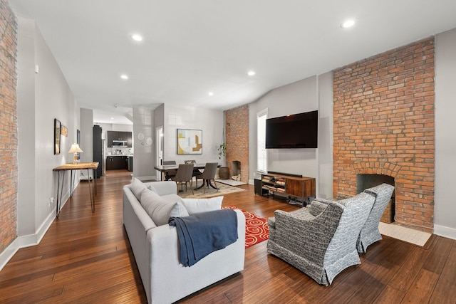 144 Wilson Ave, Columbus, OH 43205 - living room with wood-type flooring, recessed lighting, brick wall, and a fireplace