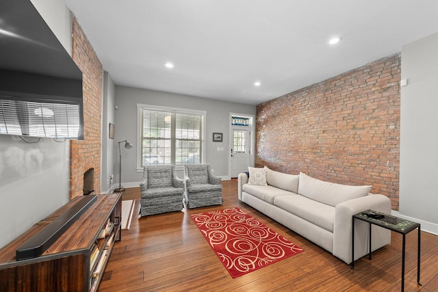 144 Wilson Ave, Columbus, OH 43205 - living area with brick wall, wood finished floors, a brick fireplace, and recessed lighting