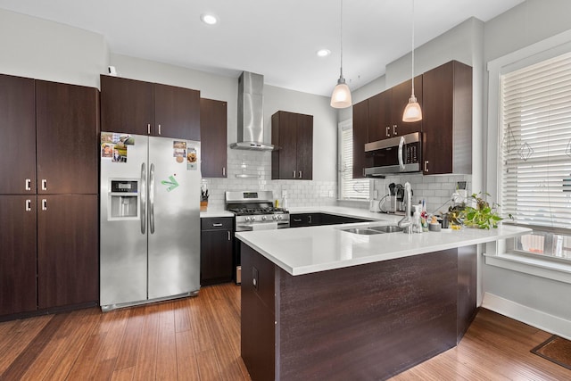 144 Wilson Ave, Columbus, OH 43205 - kitchen with stainless steel appliances, wall chimney exhaust hood, a peninsula, healthy amount of natural light, and recessed lighting