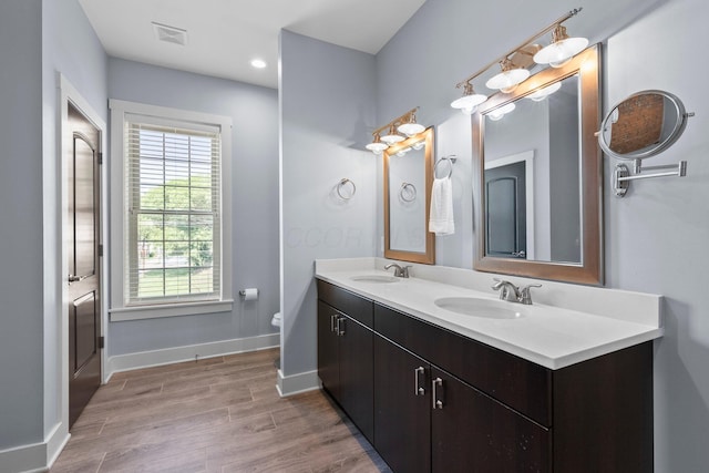 144 Wilson Ave, Columbus, OH 43205 - full bath featuring double vanity, wood finished floors, and recessed lighting
