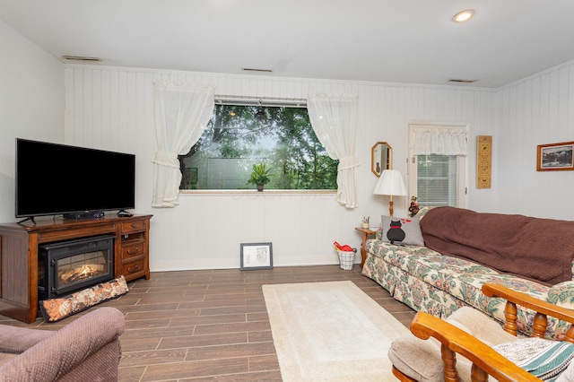 1374 Hanover Ct, Circleville, OH 43113 - living area featuring wood finished floors, recessed lighting, a glass covered fireplace, and ornamental molding