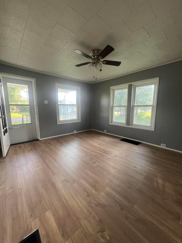 2135 Whitman Ave, Zanesville, OH 43701 - empty room featuring plenty of natural light, wood finished floors, and ceiling fan