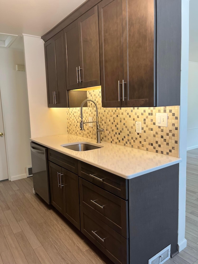 1848 Milden Rd, Columbus, OH 43221 - kitchen featuring dishwasher, light wood-style floors, light countertops, dark brown cabinets, and tasteful backsplash