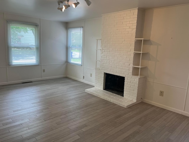 1848 Milden Rd, Columbus, OH 43221 - unfurnished living room featuring wood finished floors and a fireplace