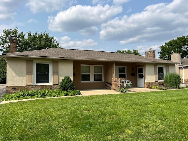 1848 Milden Rd, Columbus, OH 43221 - view of front of house featuring a chimney, a front yard, stucco siding, a patio, and brick siding