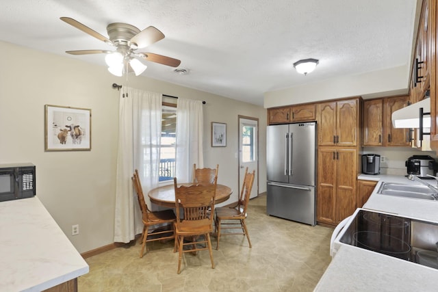 110 Creekview Dr, Baltimore, OH 43105 - kitchen featuring high end fridge, ventilation hood, brown cabinetry, and light countertops