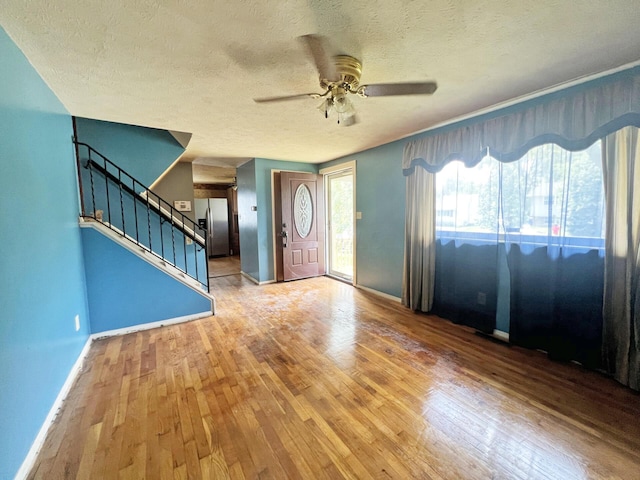 1444 Chesterton Sq N, Columbus, OH 43229 - foyer featuring hardwood / wood-style flooring, stairway, a ceiling fan, and a textured ceiling