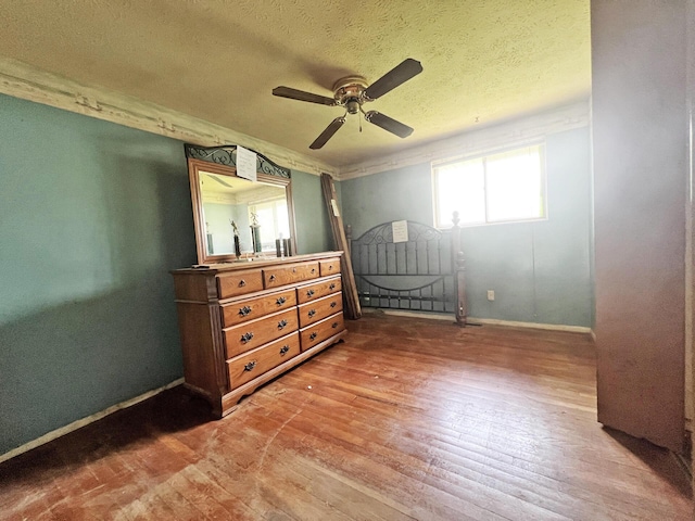 1444 Chesterton Sq N, Columbus, OH 43229 - bedroom with wood finished floors, a textured ceiling, and ceiling fan