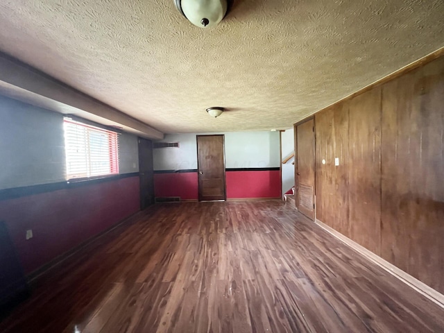 1444 Chesterton Sq N, Columbus, OH 43229 - empty room featuring wood finished floors, a textured ceiling, wood walls, and stairway