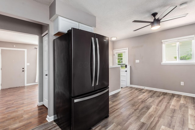 284 Blendon Rd, West Jefferson, OH 43162 - kitchen with freestanding refrigerator, white cabinets, ceiling fan, light wood-type flooring, and a textured ceiling