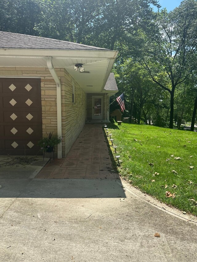 1080 Sycamore Dr, Lancaster, OH 43130 - property entrance featuring brick siding, a lawn, a shingled roof, and a garage