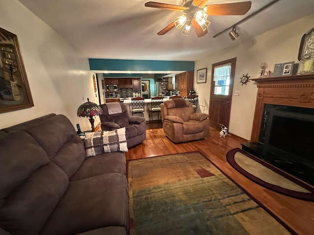 1080 Sycamore Dr, Lancaster, OH 43130 - living area featuring wood finished floors, a ceiling fan, and a fireplace with raised hearth