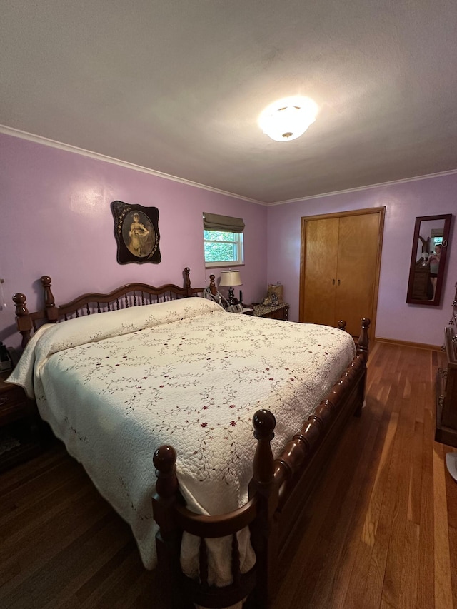 1080 Sycamore Dr, Lancaster, OH 43130 - bedroom with ornamental molding, dark wood-style flooring, and a closet