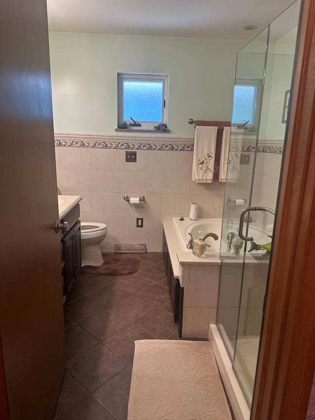 1080 Sycamore Dr, Lancaster, OH 43130 - bathroom featuring vanity, tile patterned floors, a shower stall, a garden tub, and a wainscoted wall