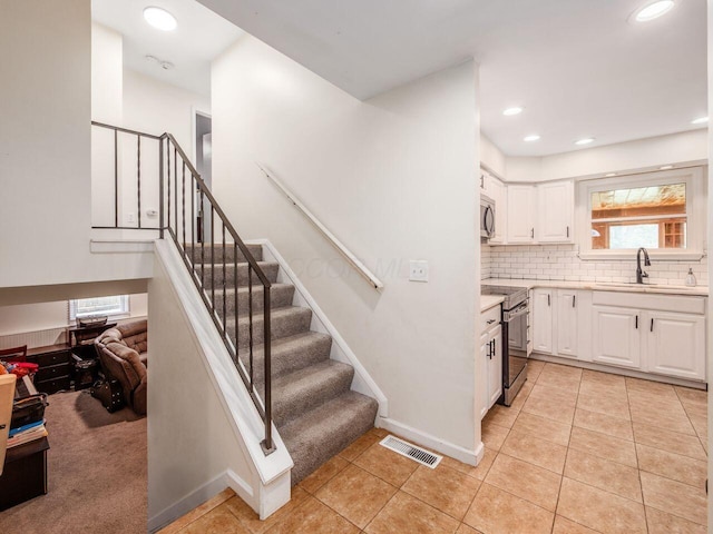 2010 Shallowford Ave, Columbus, OH 43235 - stairs with healthy amount of natural light, tile patterned flooring, and recessed lighting
