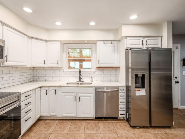 2010 Shallowford Ave, Columbus, OH 43235 - kitchen featuring appliances with stainless steel finishes, white cabinets, light countertops, tasteful backsplash, and recessed lighting