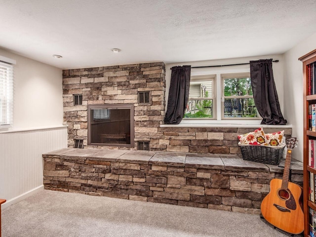 2010 Shallowford Ave, Columbus, OH 43235 - unfurnished living room featuring a wainscoted wall, carpet, and a stone fireplace