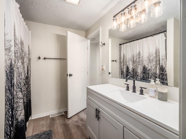 2010 Shallowford Ave, Columbus, OH 43235 - full bathroom featuring wood finished floors, vanity, and a textured ceiling