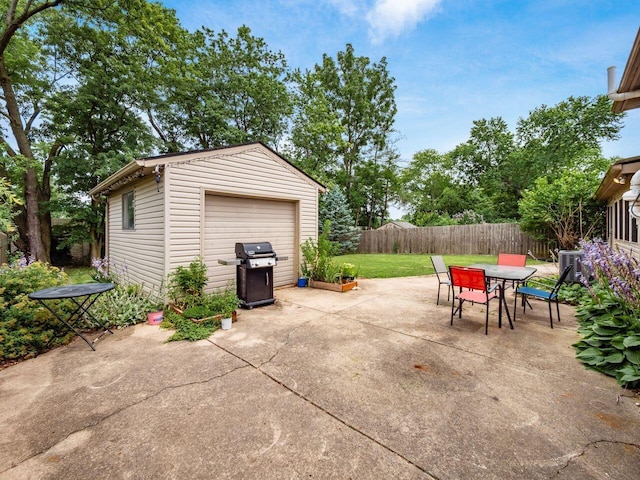 2010 Shallowford Ave, Columbus, OH 43235 - fenced backyard with a grill, a garage, outdoor dining area, an outbuilding, and a patio