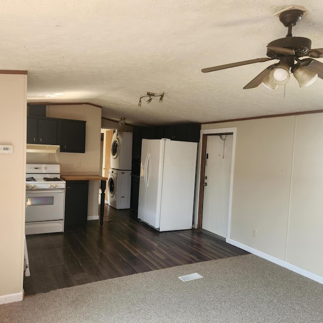 3137 Westerville Rd Unit 91, Columbus, OH 43224 - kitchen featuring white appliances, stacked washing machine and dryer, under cabinet range hood, a ceiling fan, and dark cabinets