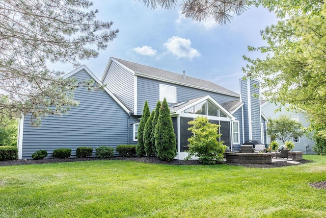419 Wooten Ct S, Powell, OH 43065 - back of property with a sunroom, a lawn, and a chimney