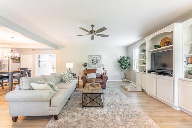 419 Wooten Ct S, Powell, OH 43065 - living room with light wood-style floors, a ceiling fan, and a chandelier