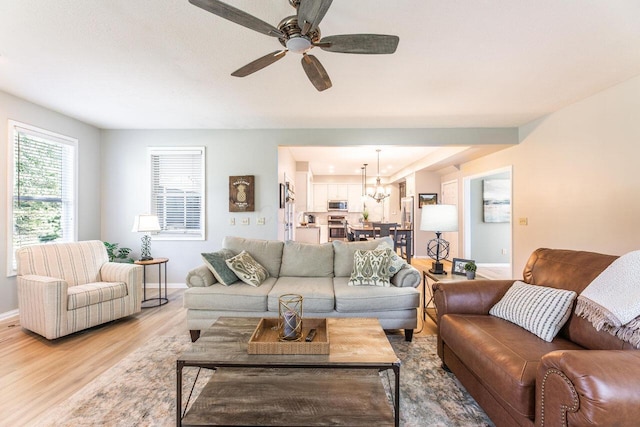 419 Wooten Ct S, Powell, OH 43065 - living room featuring light wood finished floors, a chandelier, and ceiling fan