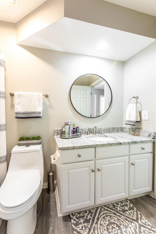 419 Wooten Ct S, Powell, OH 43065 - bathroom with wood finished floors and vanity