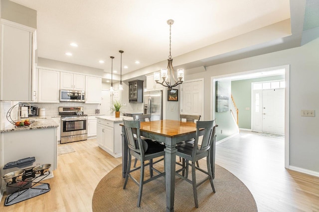 419 Wooten Ct S, Powell, OH 43065 - dining space with light wood-type flooring, a chandelier, and recessed lighting