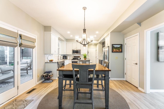 419 Wooten Ct S, Powell, OH 43065 - dining space featuring a chandelier, light wood-type flooring, and recessed lighting
