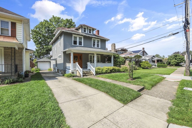 206 E Fair Ave, Lancaster, OH 43130 - american foursquare style home with covered porch, concrete driveway, an outbuilding, a front lawn, and a detached garage