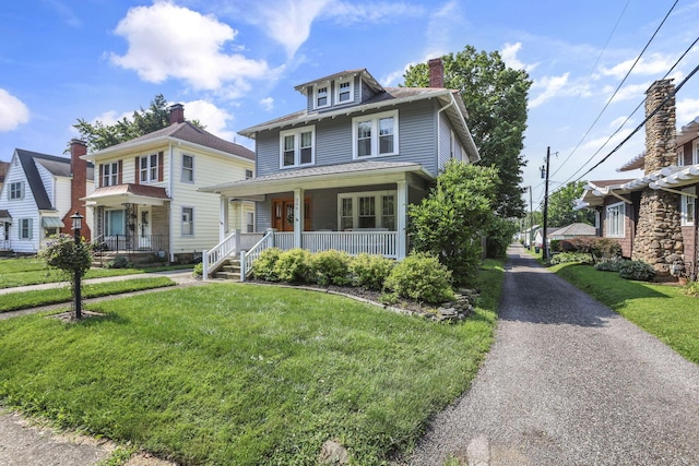 206 E Fair Ave, Lancaster, OH 43130 - american foursquare style home featuring a porch, a front yard, and a chimney