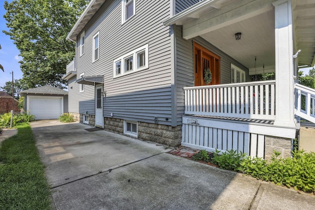 206 E Fair Ave, Lancaster, OH 43130 - view of side of property featuring an outbuilding, concrete driveway, a garage, and covered porch