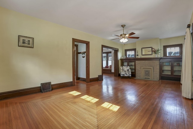 206 E Fair Ave, Lancaster, OH 43130 - unfurnished living room featuring ceiling fan, wood finished floors, and a fireplace