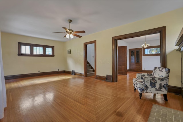 206 E Fair Ave, Lancaster, OH 43130 - unfurnished living room with stairway, healthy amount of natural light, hardwood / wood-style flooring, and ceiling fan