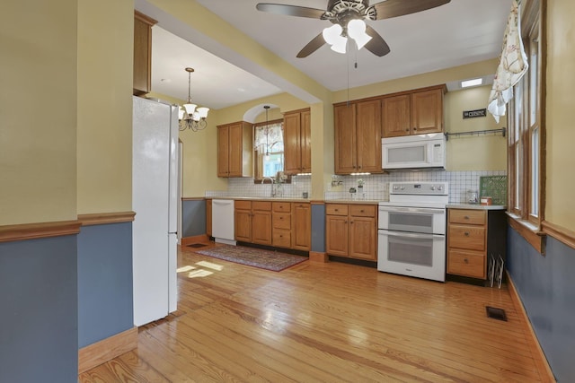 206 E Fair Ave, Lancaster, OH 43130 - kitchen with white appliances, light wood-style flooring, light countertops, and tasteful backsplash