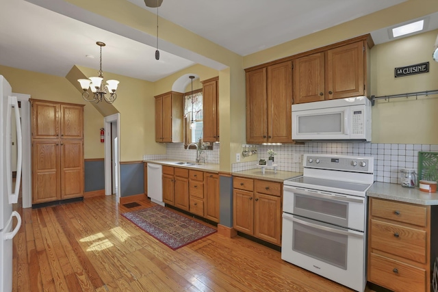 206 E Fair Ave, Lancaster, OH 43130 - kitchen with white appliances, light wood-type flooring, light countertops, and brown cabinets